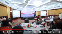 View of stage as attendees listen to the presenter